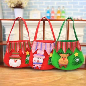 Three Christmas felt gift bags featuring Santa, snowman, and reindeer cartoon characters