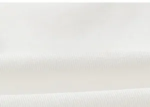 Close-up macro view of high-quality white cotton fabric texture on children's long sleeve top