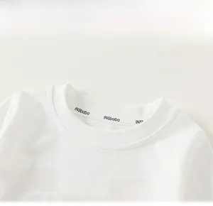 Detail of white cotton toddler T-shirt featuring a blue cloud print and round neckline