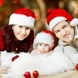Classic red plush Christmas hats for adults and kids in a warm family holiday setting