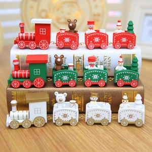 Three wooden Christmas train ornaments in red, green, and white colors for holiday decor