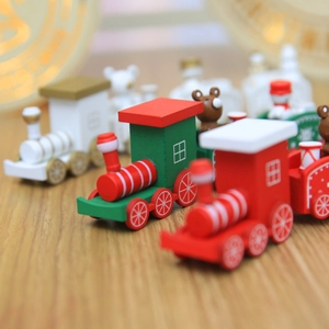 Classic wooden Christmas train decoration with festive red and green colors on wood surface