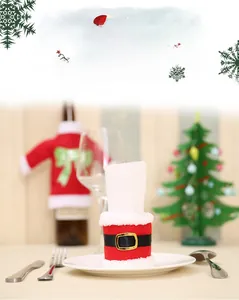 Detail of Santa Claus costume napkin ring with red fabric and gold buckle on a festive table