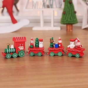 Classic red and green wooden Christmas train set with Santa Claus on a rustic table