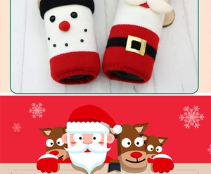 Detail of knitted Christmas wine bottle covers featuring Santa and snowman designs