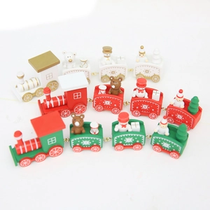 Three decorative wooden Christmas trains in red, green and white with festive figurines