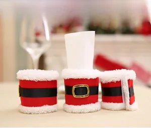 Detail of red Christmas napkin rings with white faux fur trim and belt buckle design