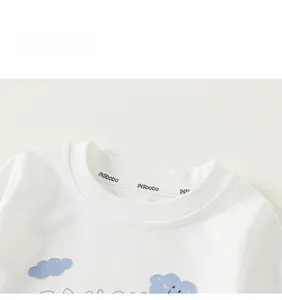 Close-up of white ribbed crew neck with blue cloud print and fine knit texture