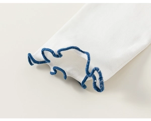 Detail of white ribbed cotton t-shirt sleeve with blue contrast lettuce edge trim