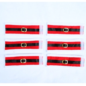 Detail view of 6 Santa belt napkin rings with red fabric and gold buckles for Christmas