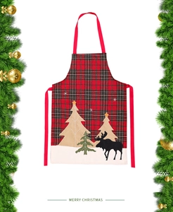 Close-up of Christmas apron with red plaid fabric, reindeer and tree embroidery detail