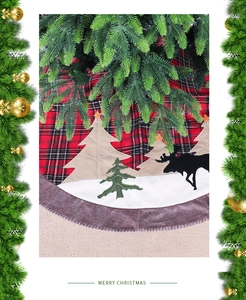 Detail of red and black plaid Christmas tree skirt with reindeer and tree embroidery