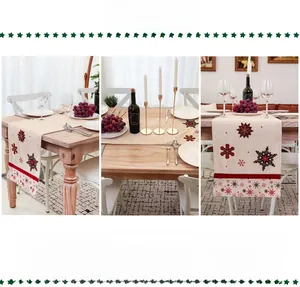 Close-up of Nordic Christmas table runner with red snowflake embroidery and cotton linen texture