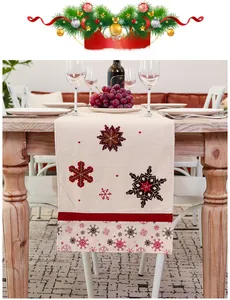 Close-up of Nordic Christmas table runner with embroidered snowflakes and red border detail