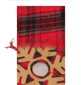 Detailed fabric texture of red and black checkered Christmas tree skirt with snowflake appliqué