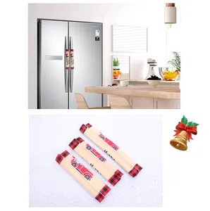 Detail of Christmas fridge handle covers with vintage red truck and merry christmas text