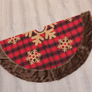 Red and black plaid Christmas tree skirt with faux fur trim and gold snowflake patterns
