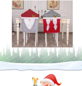 Detail of Christmas chair covers featuring gnome designs with red and black plaid hats