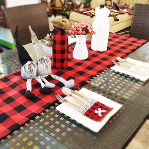 Christmas table decoration set featuring red black plaid runner and gnome dolls