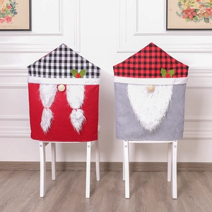 Christmas Gnome chair covers with buffalo plaid tops and festive holly leaf decorations