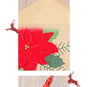 Close-up of burlap table runner with red poinsettia embroidery and hanging tassels