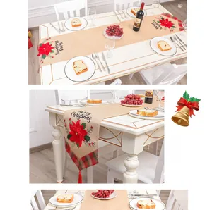 Detail of Christmas table runner featuring red flower embroidery and festive tassels