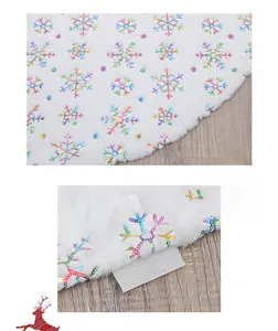 Close-up of white plush Christmas tree skirt featuring colorful sequin snowflake embroidery