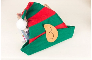 Detail of red and green striped Christmas elf hat with plush ball and fabric ears