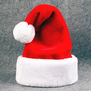 Classic plush red Christmas hat with white faux fur trim and pompom on gray felt