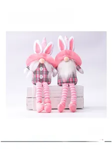 Detail of pink Easter gnome plush with rabbit ears and checkered fabric texture