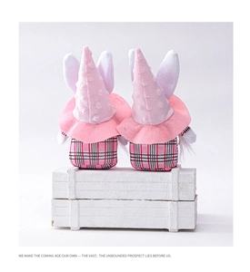 Rear view of pink Easter gnome plushies with rabbit ears and checkered fabric details