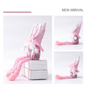 Detailed view of pink Easter gnome plush with bunny ears and pink checkered pattern fabric