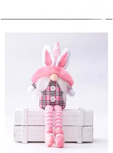 Detail of plush Easter gnome with pink rabbit ears and red black checkered clothing
