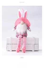 Detail of Easter gnome with pink bunny ears and plaid outfit on vintage white crate