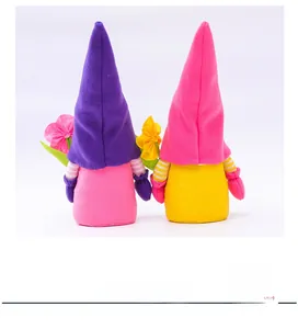 Detail of plush flower gnome dolls in purple and pink with soft felt and faux fur textures