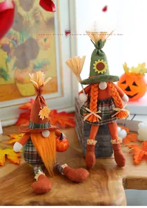 Detail showing orange autumn gnome couple with pumpkin and broom for harvest decor