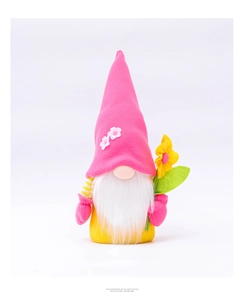 Pink gnome plush toy with long white beard and yellow felt body holding a felt flower