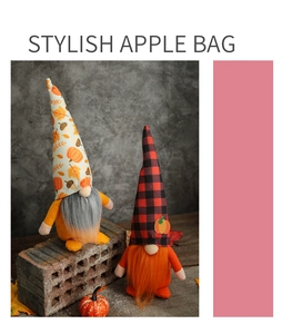 Detailed view of fall-themed plush gnomes with orange clothes and pumpkin maple leaf hats