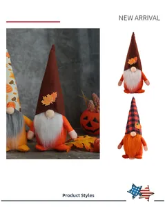 Close-up of autumn harvest gnomes featuring maple leaves, pumpkin decor and plaid hats