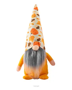Macro shot of plush autumn gnome with pumpkin and acorn patterns on the warm orange hat