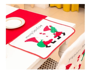 Detail of Christmas table mat featuring embroidered gnomes and Merry Christmas lettering
