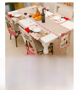 Close-up of linen Christmas chair covers and table runner with Santa Claus embroidery