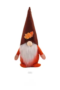 Detailed view of harvest gnome plush with orange body and maple leaf decorated hat