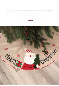 Detail of burlap Christmas tree skirt featuring Santa Claus and Merry Christmas embroidery