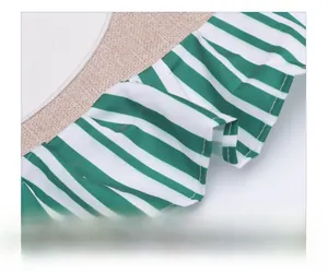 Close-up of green and white striped fabric edge with neat stitching on a chair cover