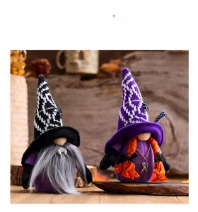 Detail of vampire Halloween gnomes with spider hats and orange braids on wooden background