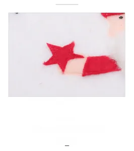 Close-up of Christmas placemat featuring embroidered felt gnome with red star details