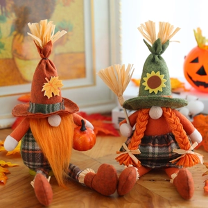 Handmade Autumn Thanksgiving gnome couple with orange pumpkins and festive maple leaf accents
