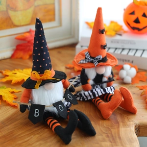 Coppia di gnomi di Halloween in peluche con cappelli a punta su un tavolo di legno