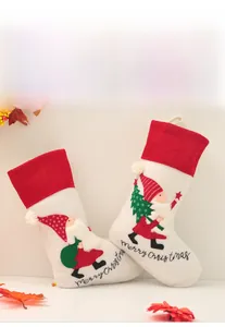 Detail view of plush Christmas stockings with 3D embroidery and Merry Christmas text